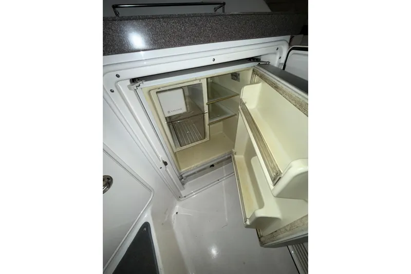 Easy Roller Yacht Photos Pics Open refrigerator inside 2009 Regal Commodore 3760 IO boat, showing shelves and door storage.