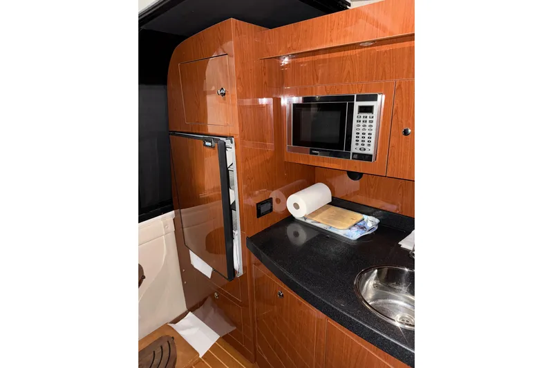 Easy Roller Yacht Photos Pics 2009 Regal Commodore 3760 IO yacht kitchen with microwave, fridge, and sink.