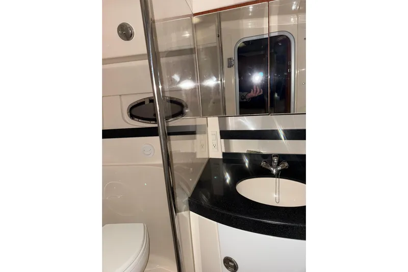 Easy Roller Yacht Photos Pics 2009 Regal Commodore 3760 IO bathroom with sink, mirror, and toilet.