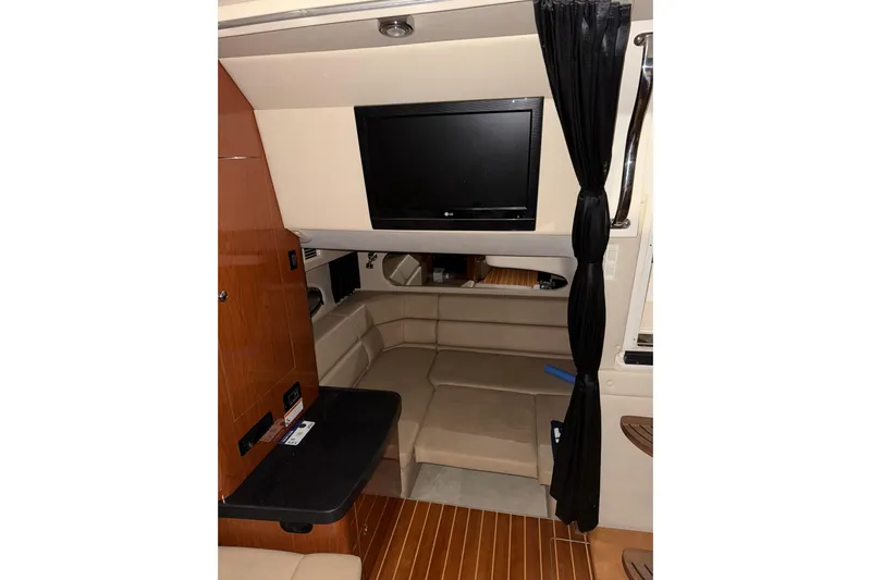 Easy Roller Yacht Photos Pics 2009 Regal Commodore 3760 IO interior with TV, seating, and wood accents.