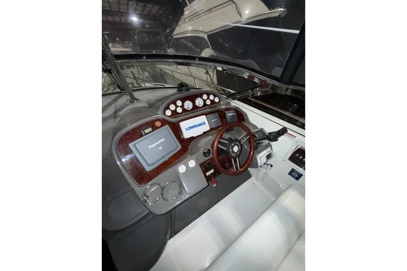 Easy Roller Yacht Photos Pics 2009 Regal Commodore 3760 IO boat dashboard with navigation equipment and steering wheel.