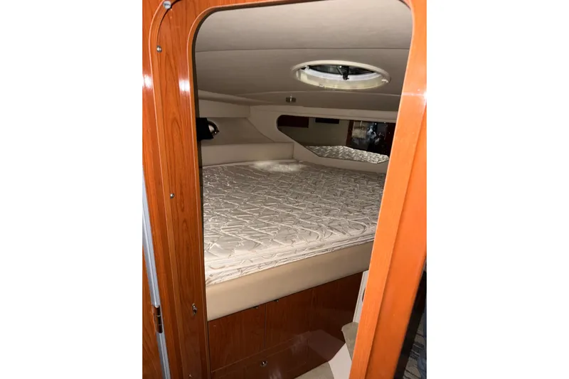 Easy Roller Yacht Photos Pics 2009 Regal Commodore 3760 IO cabin interior with bed and wooden finish.