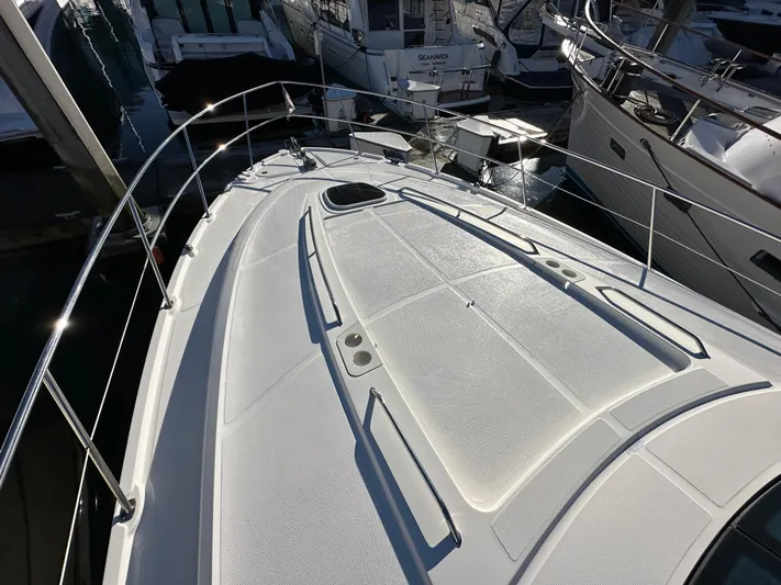  Yacht Photos Pics 2012 Sea Ray 470 Sundancer yacht deck, docked among other boats.