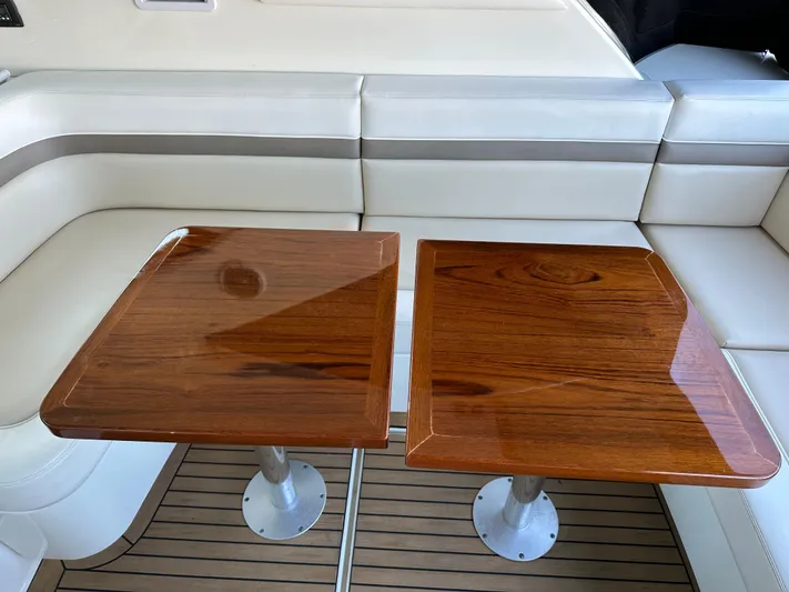  Yacht Photos Pics Luxurious interior of 2012 Sea Ray 470 Sundancer with elegant wooden tables and plush seating.