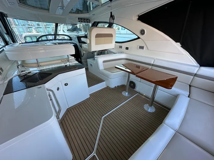  Yacht Photos Pics Interior of 2012 Sea Ray 470 Sundancer yacht with modern seating and wooden table.