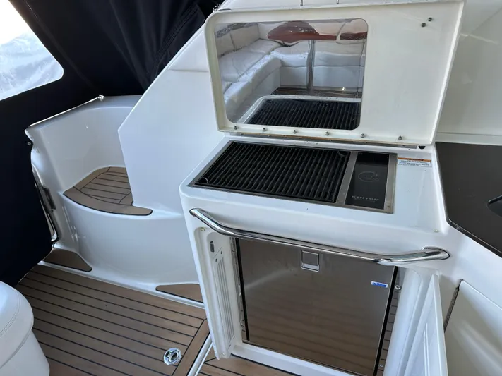 Yacht Photos Pics 2012 Sea Ray 470 Sundancer yacht interior with grill and mini-fridge on teak deck.