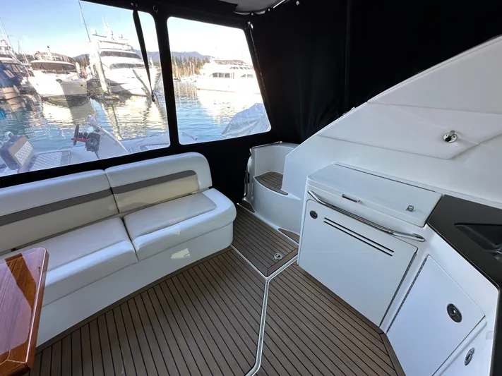  Yacht Photos Pics Interior of 2012 Sea Ray 470 Sundancer yacht with seating and kitchenette, docked at marina.