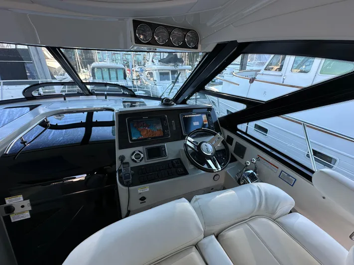  Yacht Photos Pics Interior cockpit of 2012 Sea Ray 470 Sundancer yacht with modern navigation equipment.