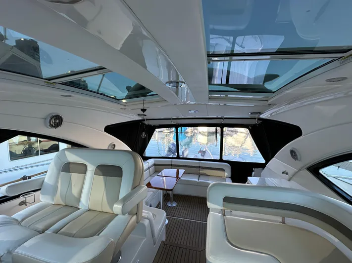  Yacht Photos Pics Luxurious interior of 2012 Sea Ray 470 Sundancer yacht with plush seating and panoramic windows.