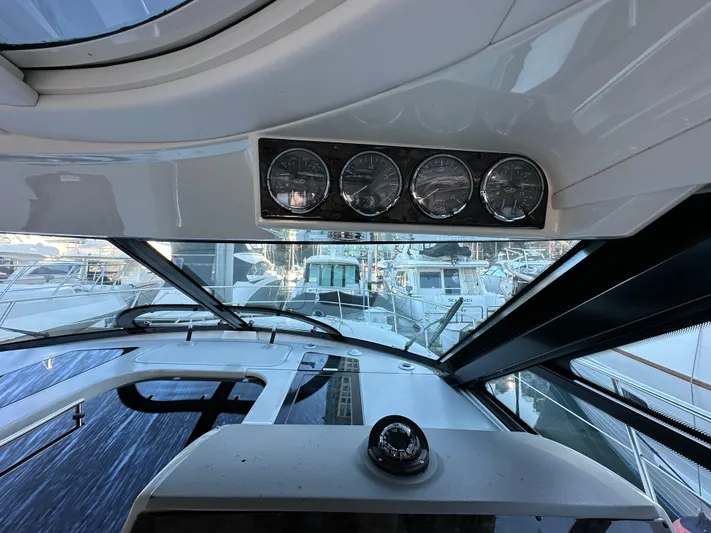  Yacht Photos Pics Interior view of 2012 Sea Ray 470 Sundancer yacht cockpit with gauges and marina backdrop.