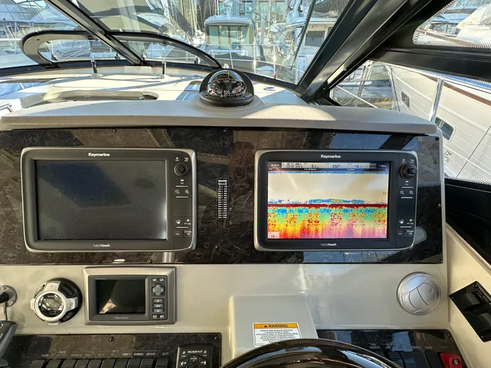  Yacht Photos Pics Dashboard of a 2012 Sea Ray 470 Sundancer with navigation screens and controls.