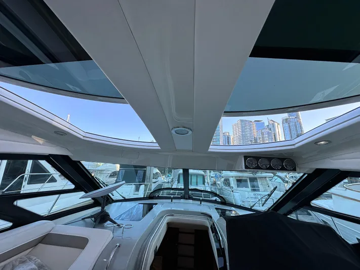  Yacht Photos Pics Interior view of 2012 Sea Ray 470 Sundancer yacht with skylights and marina backdrop.