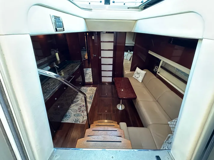  Yacht Photos Pics Luxurious interior of 2012 Sea Ray 470 Sundancer yacht with elegant seating and wood finishes.