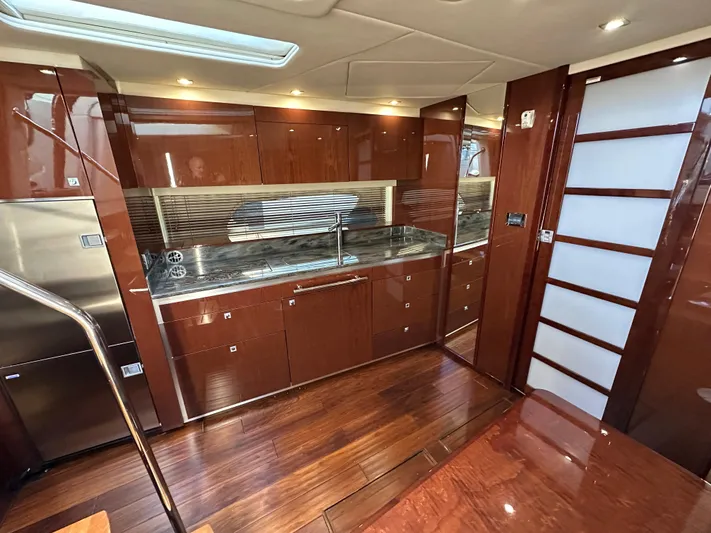  Yacht Photos Pics Luxurious interior of 2012 Sea Ray 470 Sundancer yacht with sleek wood finishes and modern kitchen.