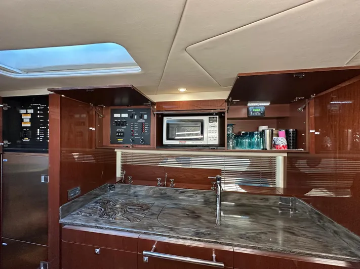  Yacht Photos Pics Luxurious kitchen interior of 2012 Sea Ray 470 Sundancer yacht with modern amenities.