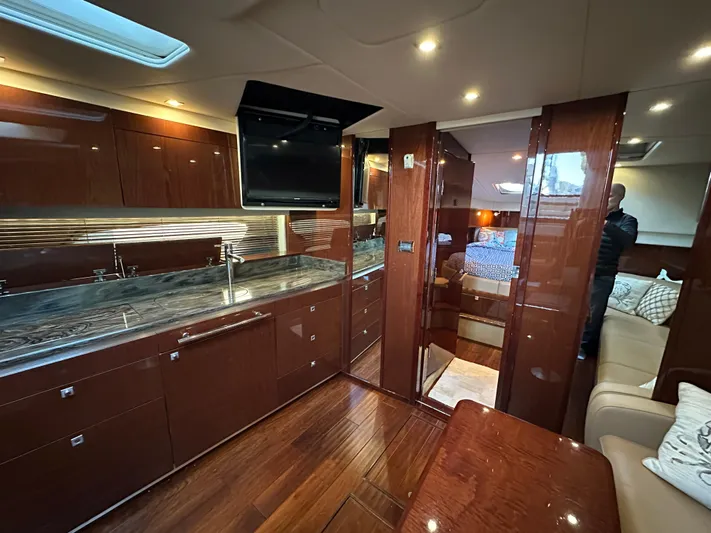  Yacht Photos Pics Luxurious interior of 2012 Sea Ray 470 Sundancer yacht with modern kitchen and cozy seating area.