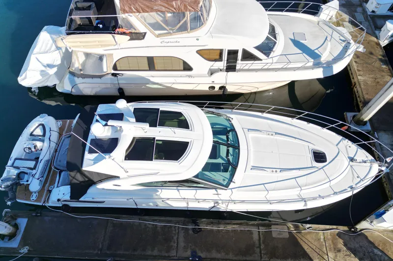  Yacht Photos Pics 2012 Sea Ray 470 Sundancer yacht docked beside another boat.