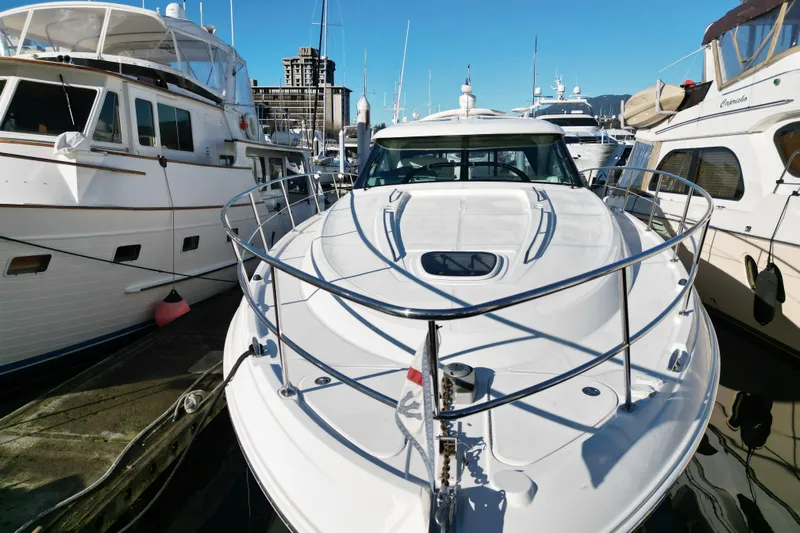  Yacht Photos Pics 2012 Sea Ray 470 Sundancer yacht docked among other boats in a marina.