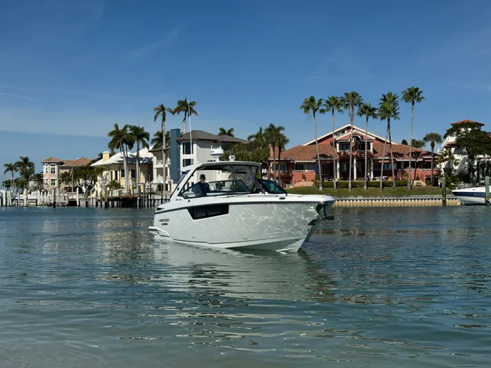 Inception Yacht Photos Pics 2023 Monterey 385 SS boat on calm water near coastal homes.