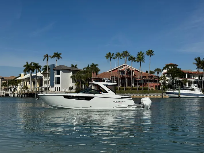 Inception Yacht Photos Pics 2023 Monterey 385 SS boat in front of coastal homes and palm trees.