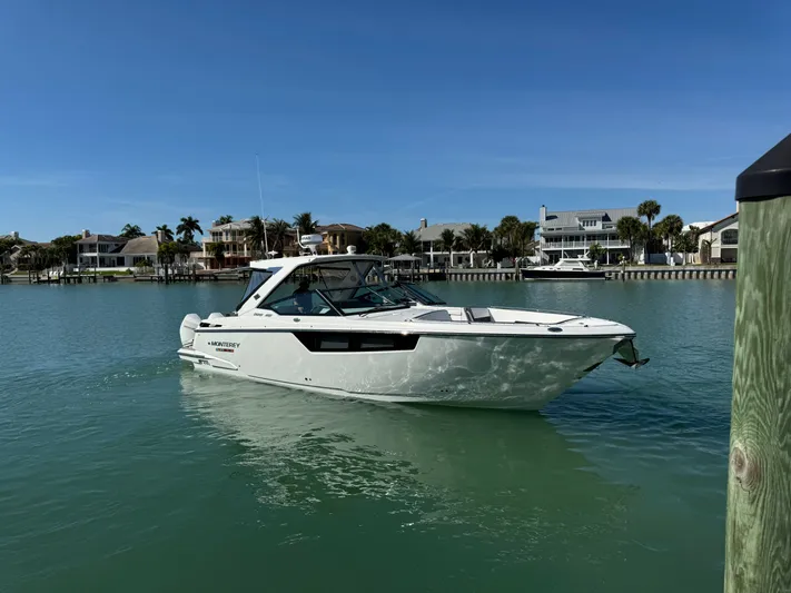 Inception Yacht Photos Pics 2023 Monterey 385 SS boat on calm water near coastal homes.