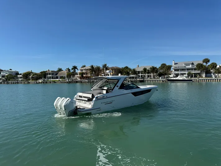 Inception Yacht Photos Pics 2023 Monterey 385 SS boat on calm water near coastal homes.