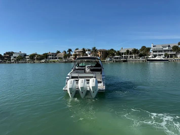 Inception Yacht Photos Pics 2023 Monterey 385 SS boat on calm water near coastal homes.