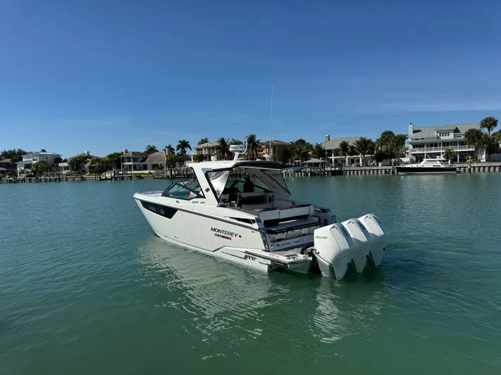 Inception Yacht Photos Pics 2023 Monterey 385 SS boat on calm water near coastal homes.