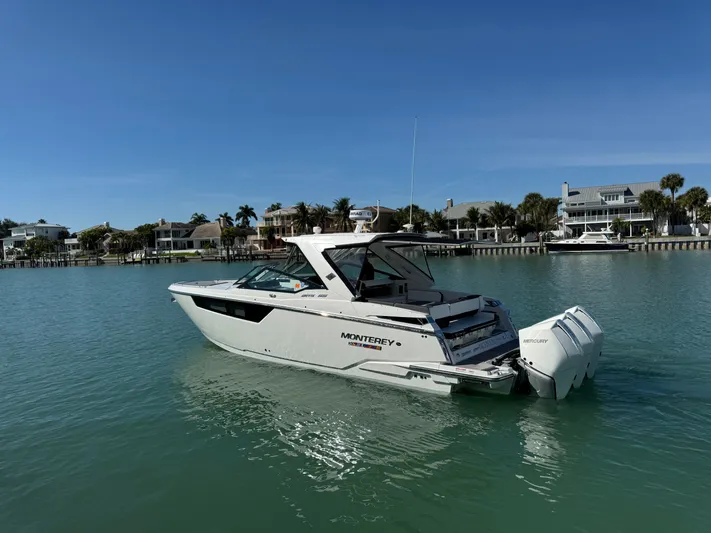 Inception Yacht Photos Pics 2023 Monterey 385 SS boat on calm water near coastal homes.
