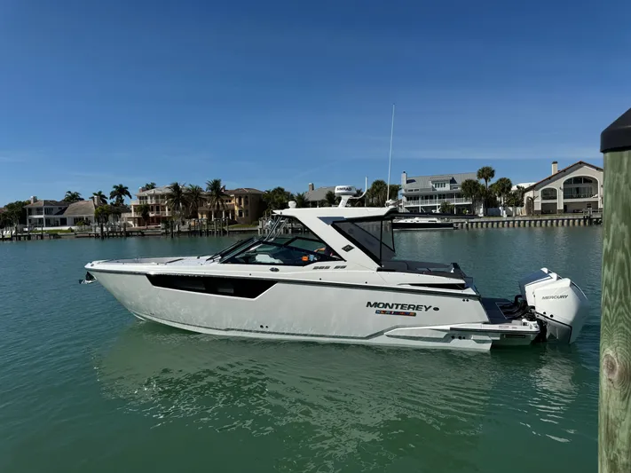 Inception Yacht Photos Pics 2023 Monterey 385 SS boat on calm water near coastal homes.