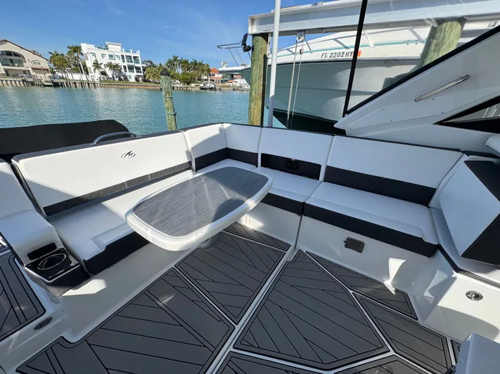 Inception Yacht Photos Pics Interior of 2023 Monterey 385 SS boat with seating area and table.