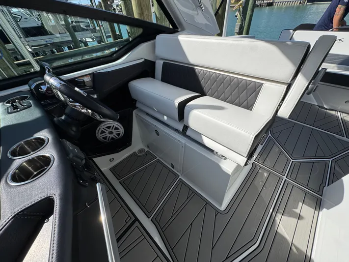 Inception Yacht Photos Pics Interior of 2023 Monterey 385 SS with modern seating and steering wheel.