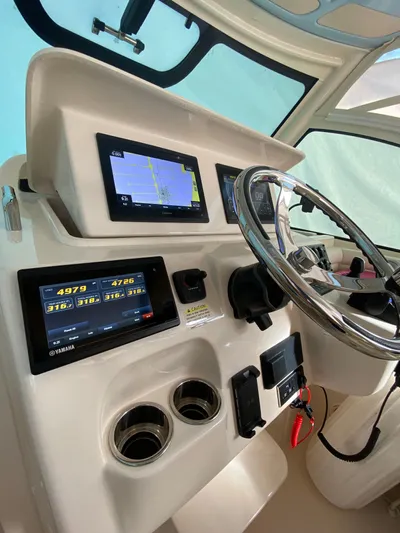 Bashquito Yacht Photos Pics 2021 Grady-White Express 330 helm with navigation screens and steering wheel.
