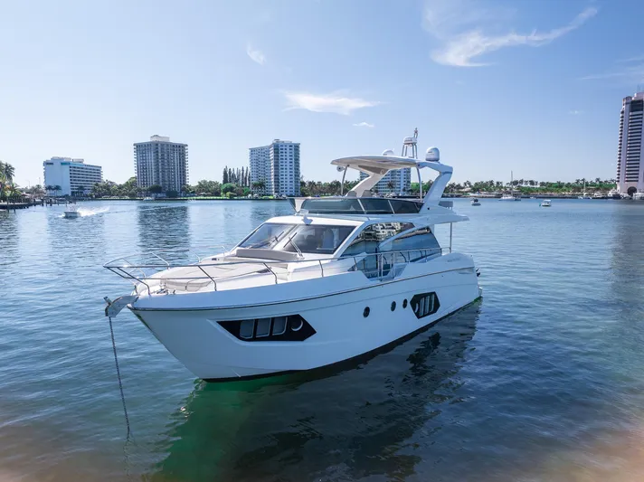 Holy Moly Yacht Photos Pics 2020 Absolute 50 Fly yacht anchored in a serene waterfront setting.