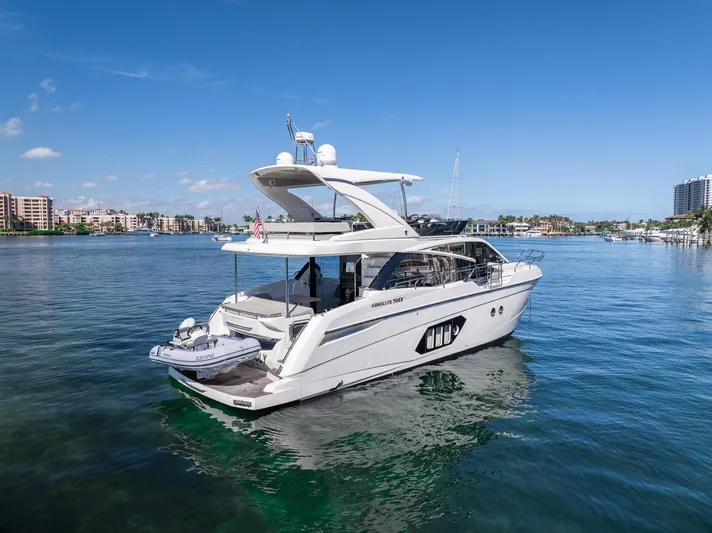 Holy Moly Yacht Photos Pics 2020 Absolute 50 Fly yacht on calm water with cityscape background.