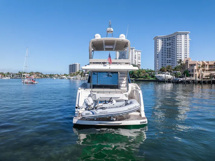 Holy Moly Yacht Photos Pics 2020 Absolute 50 Fly yacht on water, city skyline in background.