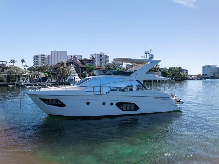 Holy Moly Yacht Photos Pics 2020 Absolute 50 Fly yacht on calm water with cityscape background.