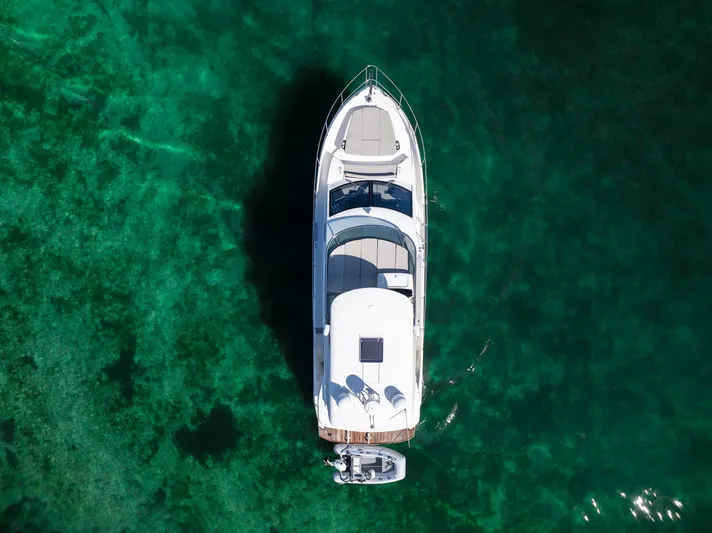 Holy Moly Yacht Photos Pics Aerial view of 2020 Absolute 50 Fly yacht on clear green water.