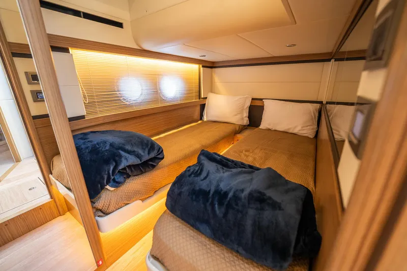 Holy Moly Yacht Photos Pics Luxurious twin cabin in 2020 Absolute 50 Fly yacht, featuring cozy bedding and modern design.