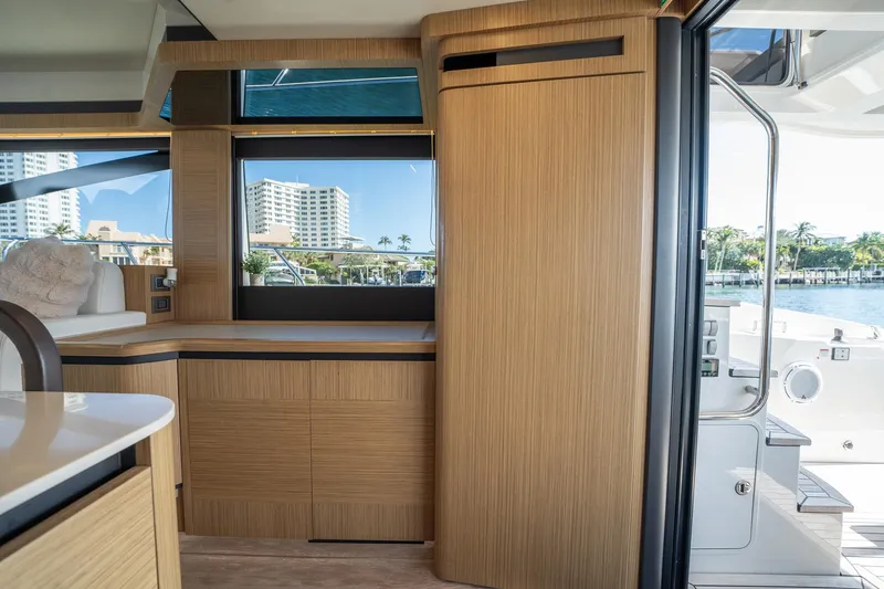Holy Moly Yacht Photos Pics Interior of 2020 Absolute 50 Fly yacht with modern wood cabinetry and waterfront view.