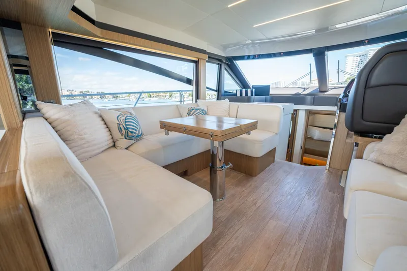 Holy Moly Yacht Photos Pics Luxurious interior of 2020 Absolute 50 Fly yacht with elegant seating and wooden flooring.
