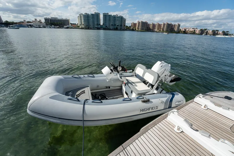 Holy Moly Yacht Photos Pics Inflatable boat docked on calm water near urban skyline, Absolute 50 Fly, 2020 model.