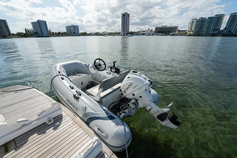 Holy Moly Yacht Photos Pics Inflatable boat docked on calm water near urban skyline, Absolute 50 Fly, 2020 model.