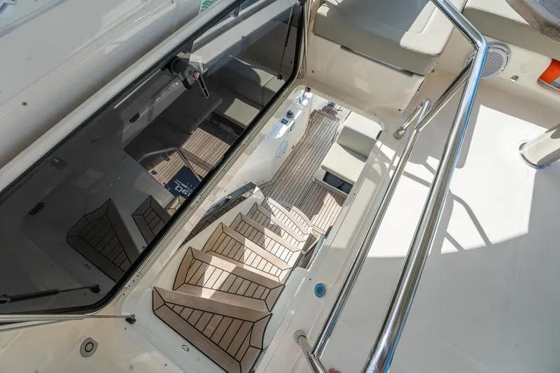 Holy Moly Yacht Photos Pics Staircase on 2020 Absolute 50 Fly yacht, featuring sleek design and wooden steps.