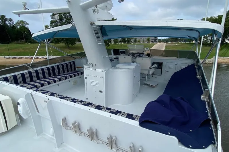  Yacht Photos Pics 1988 Burger 80 Motor Yacht deck with seating and helm, under blue canopy.