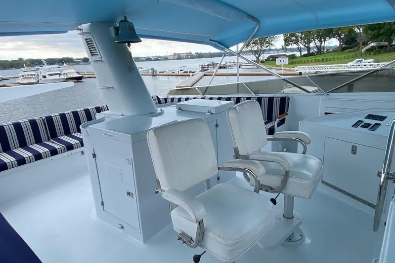  Yacht Photos Pics Cockpit of 1988 Burger 80 Motor Yacht with white seating and striped cushions.