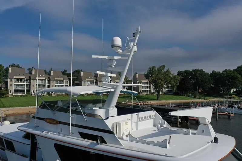  Yacht Photos Pics 1988 Burger 80 Motor Yacht docked near waterfront homes, under a clear sky.