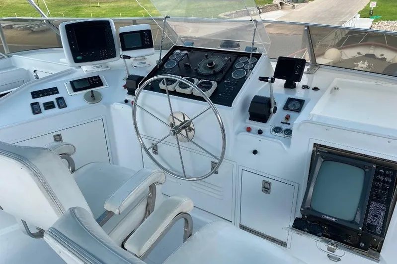  Yacht Photos Pics Cockpit of 1988 Burger 80 Motor Yacht with navigation instruments and steering wheel.