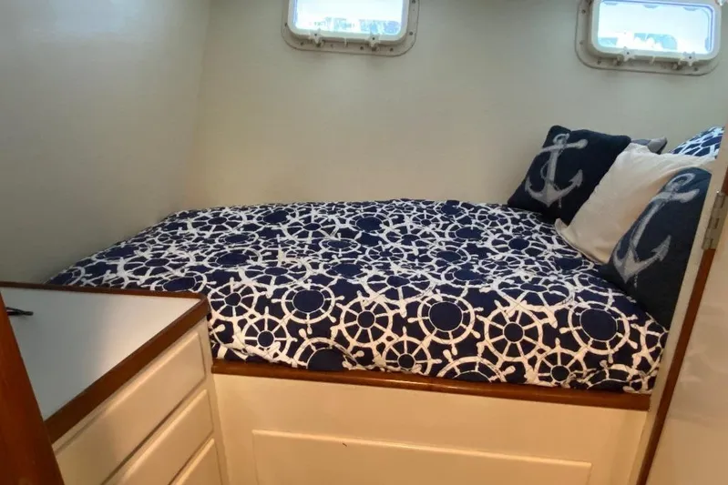  Yacht Photos Pics Cozy cabin bed with nautical-themed bedding on 1988 Burger 80 Motor Yacht.