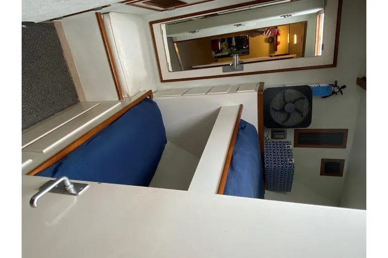  Yacht Photos Pics Interior of 1988 Burger 80 Motor Yacht with blue seating and fan.